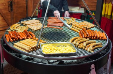 Grilled sausages assortment with french fries. Street food.