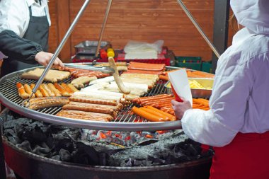 Street food background. Preparing sausages on grill. 