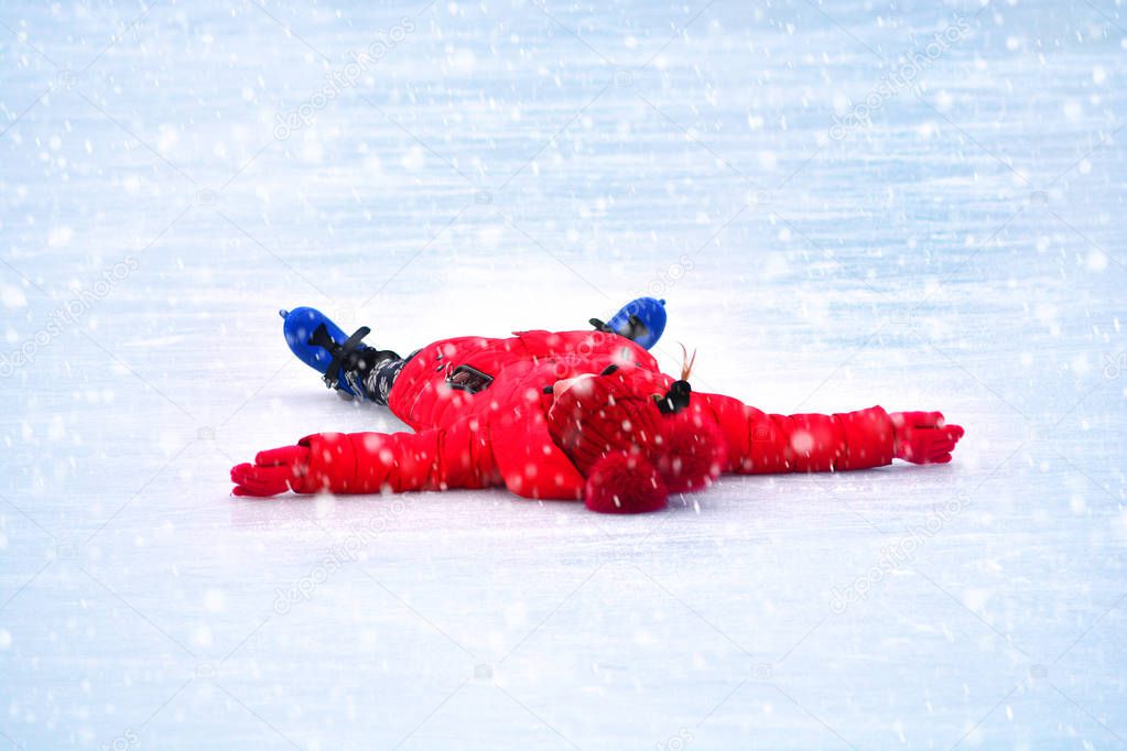 Fall on ice. Ice skating girl fell on ice.