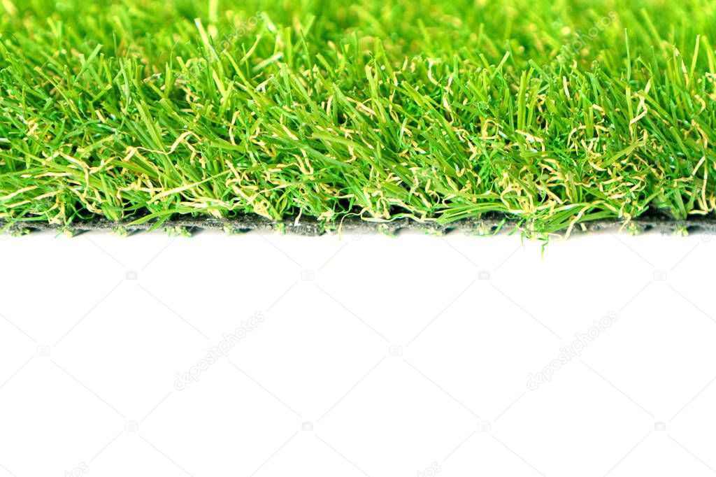 Roll of green artificial grass on the white background