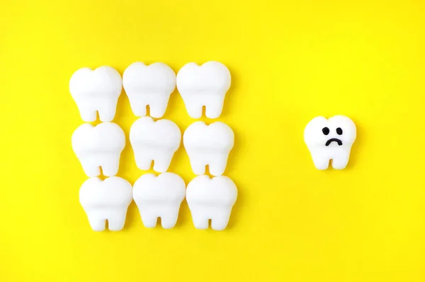 Koncepcja Próchnicy Białymi Modelami Zębów Jednym Smutnym Zębem — Zdjęcie stockowe