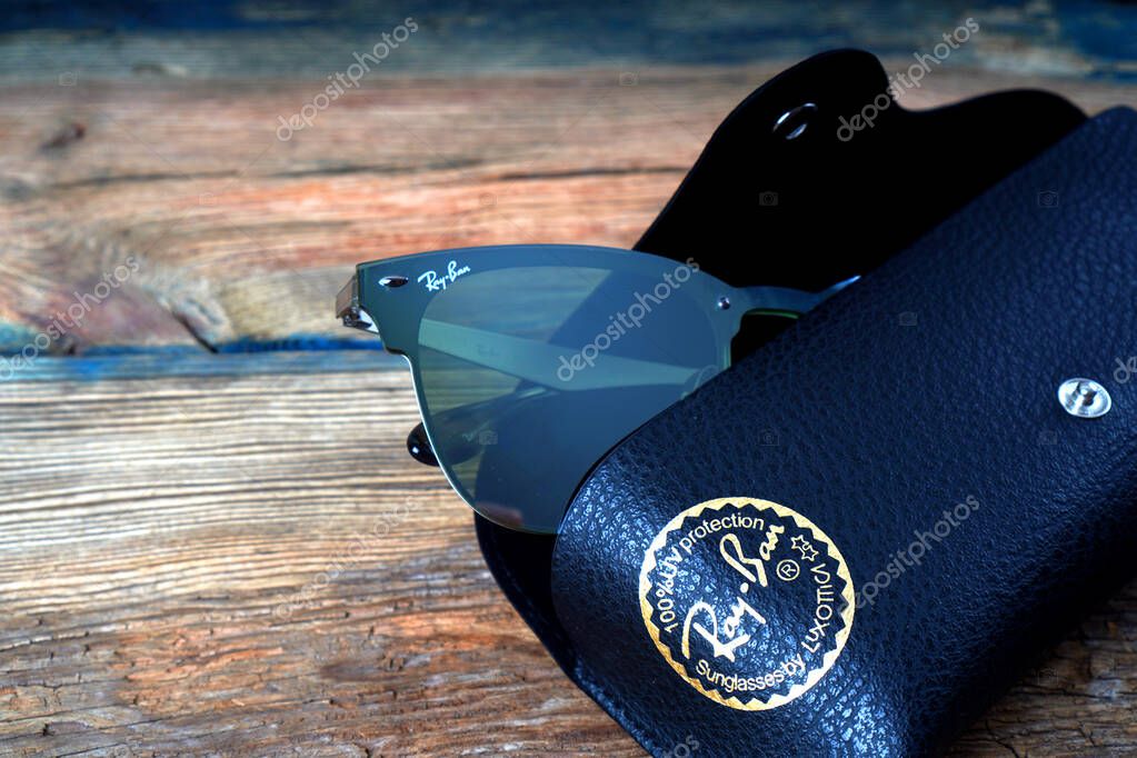 KHARKIV, UKRAINE - MARCH 12, 2020: Illustrative editorial of the fragment of Ray-Ban sunglasses in the leather case.