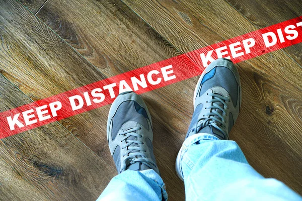 Keep distance concept with male legs near the red line