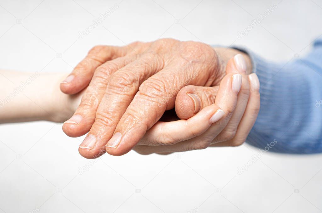 Hand giving for old woman. Young hands hold old hands. Support for the elderly concept
