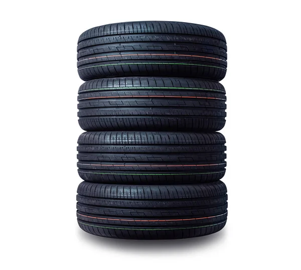 Pilha de pneus novos isolada no fundo branco — Fotografia de Stock