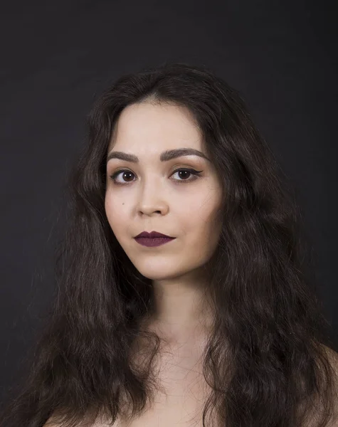 Retrato de una chica sobre un fondo oscuro. — Foto de Stock