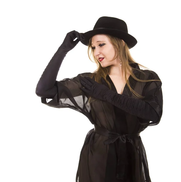 Mooi jong meisje in het zwarte tuniek, zwarte handschoenen en zwarte hoed. — Stockfoto