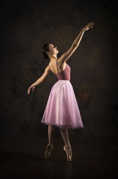 Une fille élancée dans une jupe rose et un ballet de danse beige . — Photo