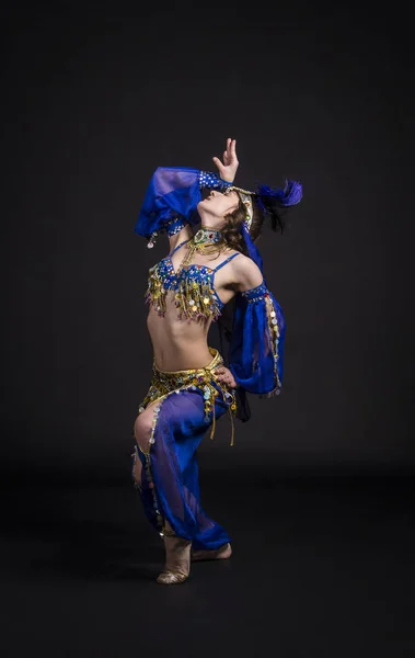 Young,smiling girl dancing the Eastern dance.Belly dance stage performance.