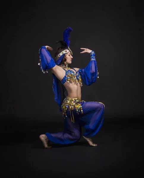 Young,smiling girl dancing the Eastern dance.Belly dance stage performance.