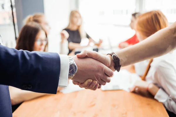 Una stretta di mano d'affari. persone blured sullo sfondo — Foto Stock