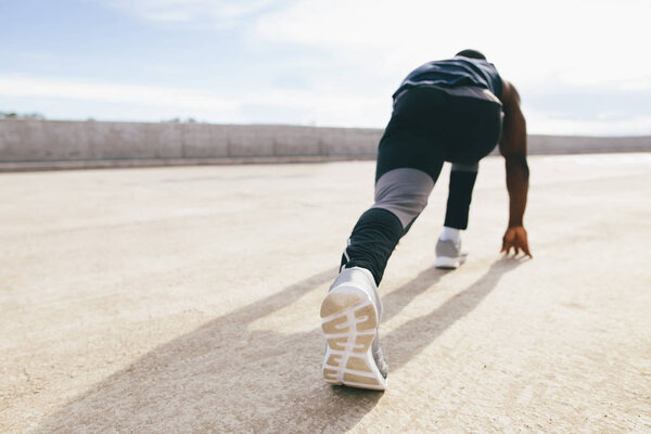 one young african muscular build man on starting pose