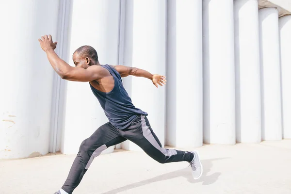 Side view of cut Black athlete sprinting on the street. — Stock Photo, Image