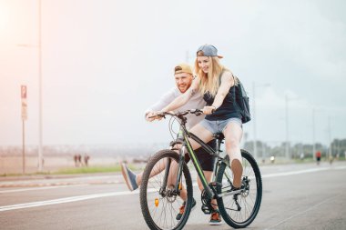 girl on bike, guy runs. boy teaches girl to ride a bike. Morning Meadow. clipart