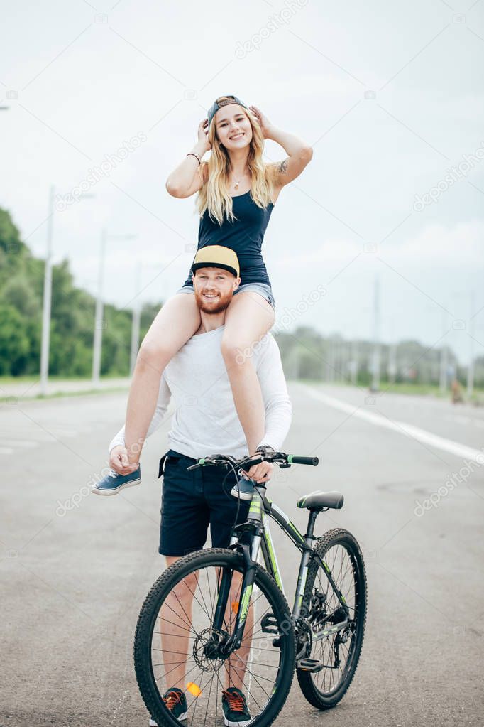 Couple riding their bikes in their free time and having fun on sunny autumn day.