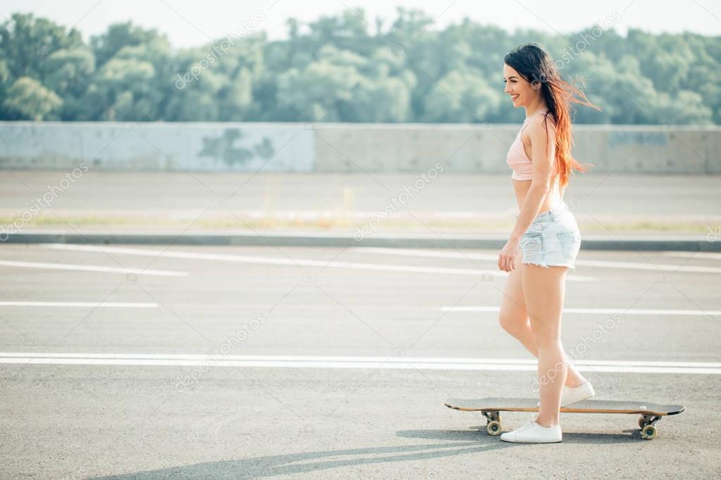 Young hipster girl posing with longboard, skateboard, street photo, life style