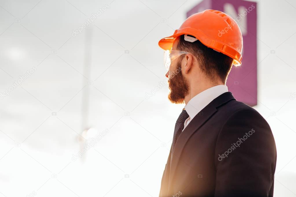 Back of business engineer wearing a helmet
