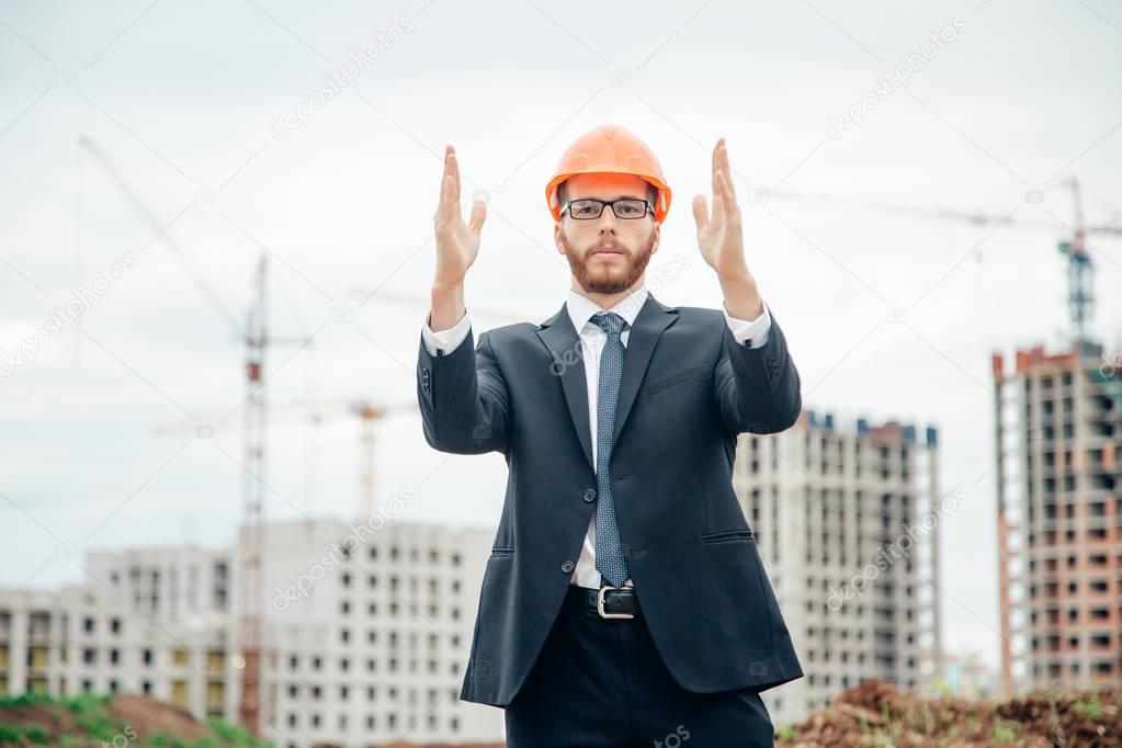 senior builder in hardhats pointing outdoors
