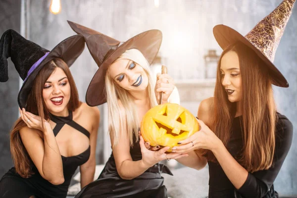 Three mistress with bright red lips, standing posing with pumpkin cutted head — Stock Photo, Image