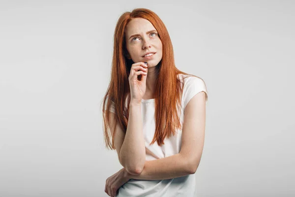 Dreamy young pretty ginger girl thinking dreaming touching chin smiling — Stock Photo, Image