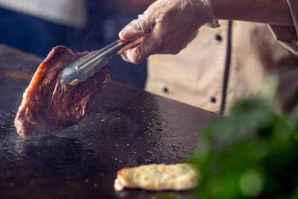 夹持煎肉。厨师正在准备猪肉 — 图库照片