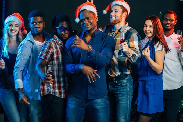 Celebrating New Year together. Group of beautiful young people in Santa hats — Stock Photo, Image