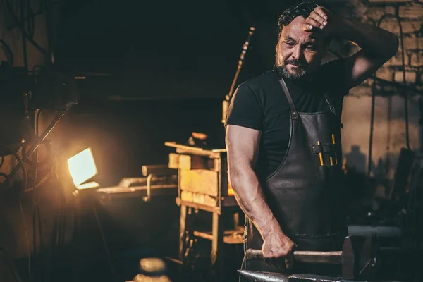 Herrero limpiar el sudor en el taller — Foto de Stock