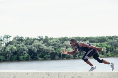 sokakta Sprint kesilmiş siyah atlet yan görünüm.