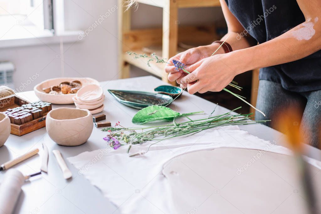 artist woman hands working red clay to create handcraft art