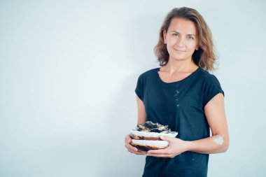 Kadın tezgahı bitmiş çatal bıçaklarla, gülümseyen seramikçi işyeri fırınlanmış fincanlarla