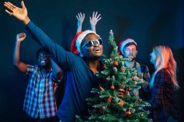 Afrika kökenli Amerikalı adam Noel ağacı ile sarılma