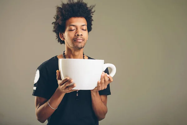 Uomo in possesso di divertente enorme e sovradimensionato tazza di caffè nero — Foto Stock