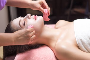 Güzellik salonunda maske takan güzel bir kadın. Fırçalı el