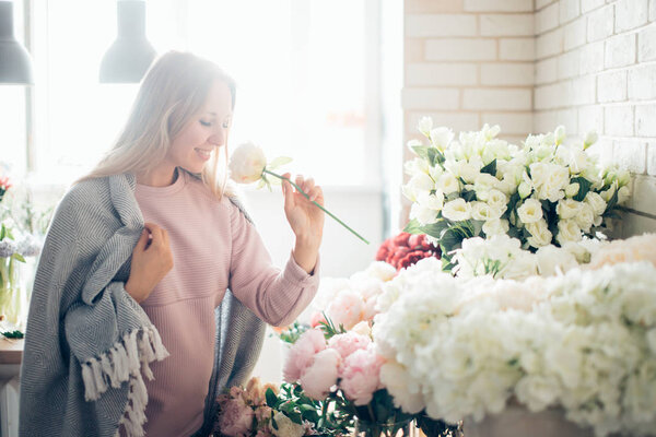 girl sniffing flowers bouquet.