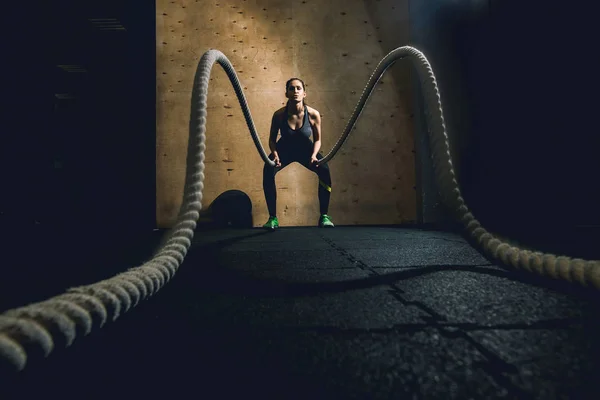 woman working out with battle ropes