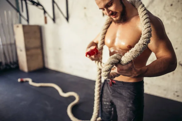 Foto do jovem em sportswear tricota o nó .Força e motivação . — Fotografia de Stock