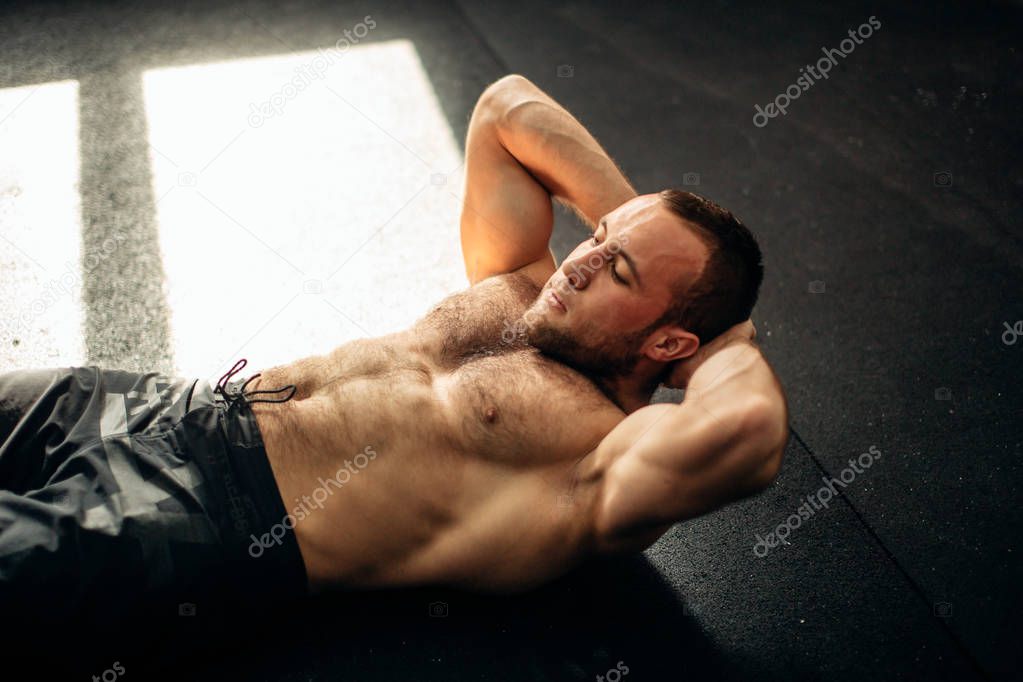 Muscular man exercising doing sit up exercise