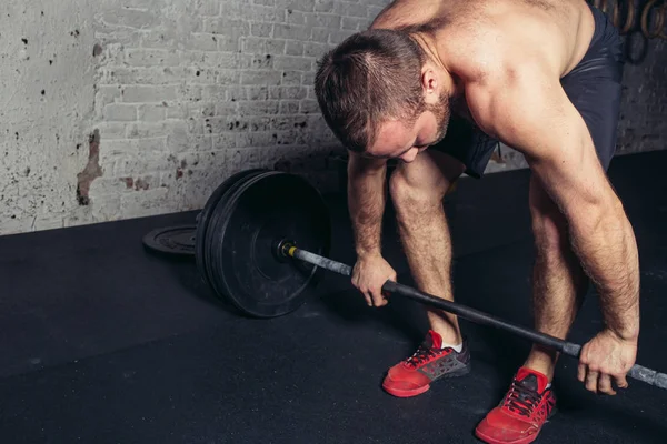 Levantador de pesas guapo preparándose para el entrenamiento con barra — Foto de Stock