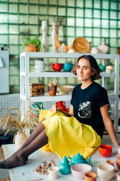 Hübsche Töpferin mit Tonbecher — Stockfoto