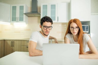 Internet birlikte oturma masa ve gülümseyen ve okuma ekranında tarama Çift