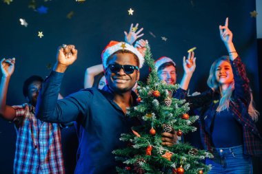 Afrika kökenli Amerikalı adam Noel ağacı ile sarılma