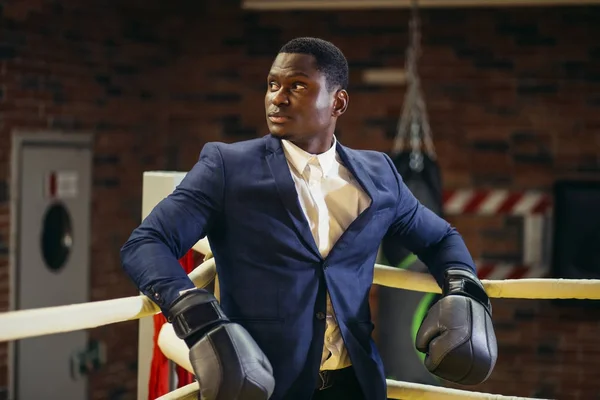 Businessman standing posture in boxing gloves