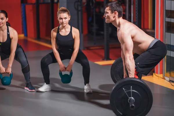 Gym group with weight lifting bar workout — Stock Photo, Image