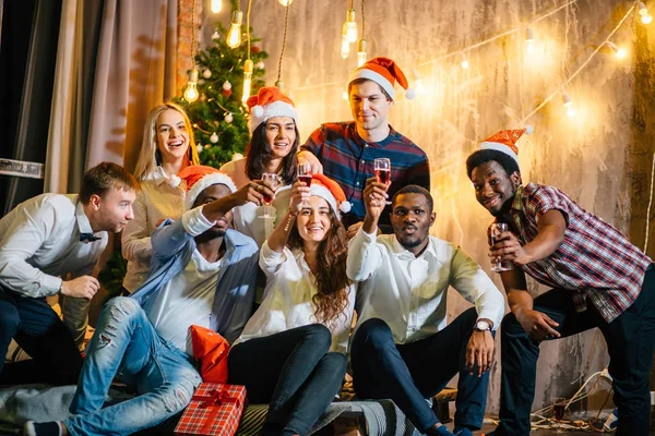 Amigos felices con champán celebrando la Navidad — Foto de Stock