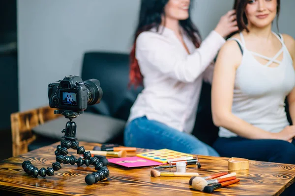 Woman making video for her blog on cosmetics using tripod mounted digital camera — Stock Photo, Image