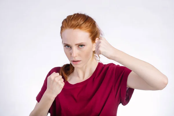 Angry woman standing with raised knuckles on white background — Stock Photo, Image