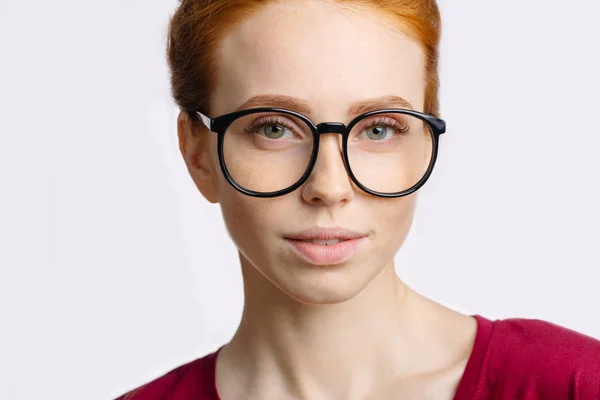Mosolyogva szemüveg vonzó fiatal vöröshajú nő portréja — Stock Fotó