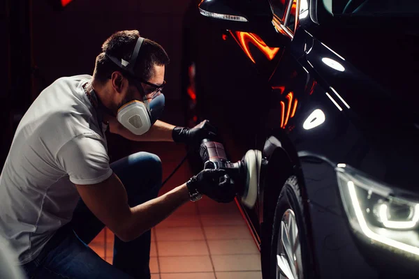 Detalles del coche - hombre con pulidor orbital en taller de reparación de automóviles. Enfoque selectivo . — Foto de Stock