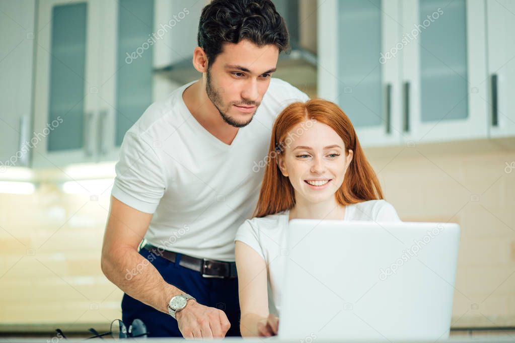 couple with laptop spending time together at home