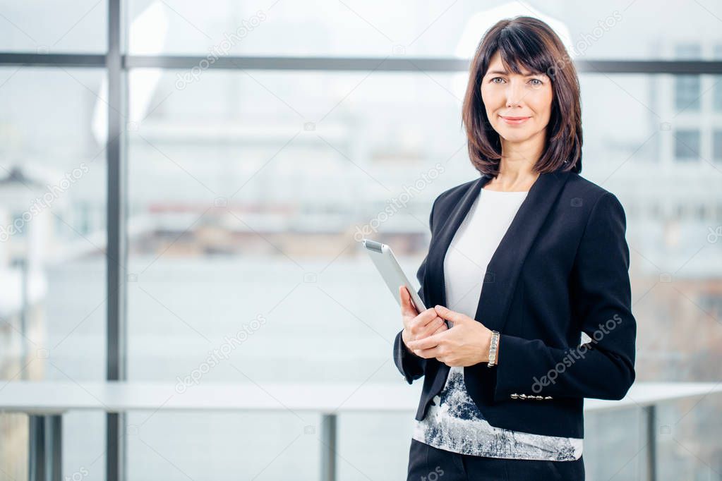 Mature Businesswoman with Digital Tablet in Office